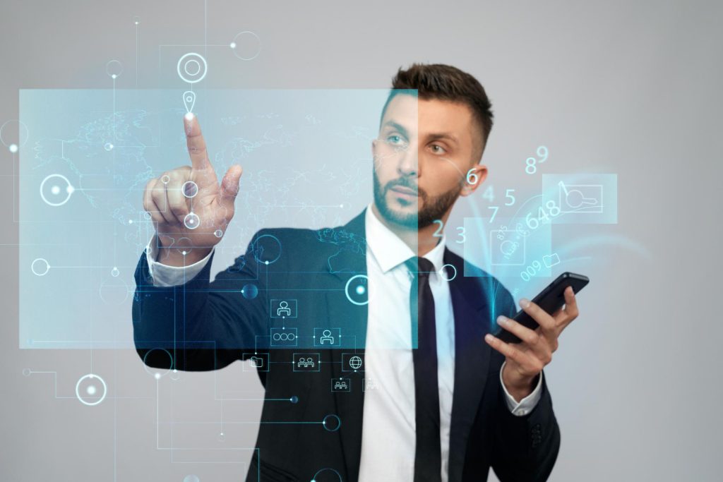 A man in a suit interacts with a virtual interface while holding a phone, illustrating AI mobile app development innovations.